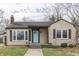 Charming single-story home featuring a bright blue front door and a cozy covered porch at 631 E 86Th St, Indianapolis, IN 46240