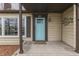 Close-up of front porch with a bright blue door, house number display, and cozy welcome mat at 631 E 86Th St, Indianapolis, IN 46240