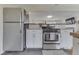 Clean kitchen features stainless appliances, white cabinets, slate flooring, and butcher block countertops at 631 E 86Th St, Indianapolis, IN 46240