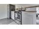 Updated kitchen with stainless steel appliances, white cabinetry, and slate flooring at 631 E 86Th St, Indianapolis, IN 46240