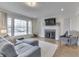 Comfortable living room with a large window and a decorative fireplace at 631 E 86Th St, Indianapolis, IN 46240