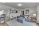 Open-concept living room with a gray sectional couch and hardwood floors at 631 E 86Th St, Indianapolis, IN 46240