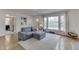 Inviting living room with a comfortable gray couch, a large window, and hardwood floors at 631 E 86Th St, Indianapolis, IN 46240