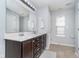 Bathroom featuring a double sink vanity, sleek lighting, and modern fixtures at 726 Jefferson Park Dr, Pittsboro, IN 46167