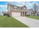 Charming two-story home with brick accents, attached two-car garage, and a well-manicured front lawn at 726 Jefferson Park Dr, Pittsboro, IN 46167