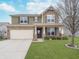 Charming two-story home with a two-car garage and a well-manicured lawn at 726 Jefferson Park Dr, Pittsboro, IN 46167