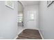 Bright foyer with hardwood floors, leading to a living space with lots of natural light and neutral paint at 726 Jefferson Park Dr, Pittsboro, IN 46167