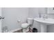Half bathroom features a white pedestal sink, toilet, and vinyl flooring at 726 Jefferson Park Dr, Pittsboro, IN 46167