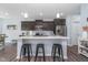 Well-lit kitchen boasts stainless steel appliances, dark wood cabinets, and a convenient island with a white countertop at 726 Jefferson Park Dr, Pittsboro, IN 46167