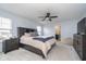 Serene main bedroom with a dark wood bed frame, soft carpeting, and plenty of natural light at 726 Jefferson Park Dr, Pittsboro, IN 46167