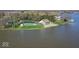 Aerial view of waterfront clubhouse with pool, beach, playground, and parking area at 788 S Harbour Dr, Noblesville, IN 46062
