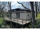 An exterior shot of a home surrounded by mature trees and featuring a wooden deck at 788 S Harbour Dr, Noblesville, IN 46062