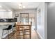 Charming dining area with wood floors, a view to the sunroom and granite countertop breakfast bar at 788 S Harbour Dr, Noblesville, IN 46062