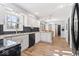 Well-lit kitchen with white cabinets, black backsplash, granite countertops, and stainless steel appliances at 788 S Harbour Dr, Noblesville, IN 46062