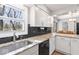 Bright kitchen featuring white cabinets, granite countertops, a black backsplash, and stainless steel appliances at 788 S Harbour Dr, Noblesville, IN 46062