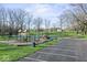 Community playground with various play structures, swings, and climbing features surrounded by trees and green space at 788 S Harbour Dr, Noblesville, IN 46062