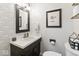 Modern powder room featuring a geometric wallpaper, stylish mirror, and updated fixtures at 788 S Harbour Dr, Noblesville, IN 46062