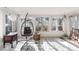 Bright sun room with decorative rug, egg chair, and plenty of natural light, offering a cozy and inviting space at 788 S Harbour Dr, Noblesville, IN 46062