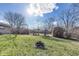 Backyard view of a fire pit and a storage shed at 7906 E 21St St, Indianapolis, IN 46219