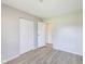 Bright bedroom featuring hardwood floors, a neutral color palette, and closet at 7906 E 21St St, Indianapolis, IN 46219