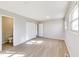 This bedroom features light grey walls, light wood-look flooring, two windows and a closet at 7906 E 21St St, Indianapolis, IN 46219