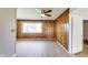 Cozy bedroom with beautiful wood paneling, ceiling fan and wood-look floors at 7906 E 21St St, Indianapolis, IN 46219