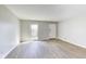 Inviting living room with wood-look floors, neutral walls and plenty of sunlight at 7906 E 21St St, Indianapolis, IN 46219