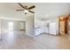 Open-concept living space with new wood-look floors and a view of the kitchen area at 7906 E 21St St, Indianapolis, IN 46219