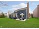 Exterior view of the house featuring a large, manicured backyard and patio area at 8228 Morel Dr, Indianapolis, IN 46256