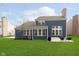 Exterior view of the house featuring a large, manicured backyard and patio area at 8228 Morel Dr, Indianapolis, IN 46256