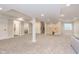 A finished basement area with gray carpet, white walls, and access to additional rooms at 8228 Morel Dr, Indianapolis, IN 46256
