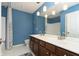 A bathroom with double sinks and blue walls at 8228 Morel Dr, Indianapolis, IN 46256