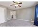Empty bedroom with light grey walls, carpet and white closet door at 8228 Morel Dr, Indianapolis, IN 46256