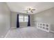 Bedroom with a ceiling fan, blue curtains, and a white shelf at 8228 Morel Dr, Indianapolis, IN 46256