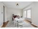 Bright dining room with large bay window, round table, vintage wooden floors, and stylish light fixture at 8228 Morel Dr, Indianapolis, IN 46256
