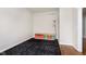 Versatile room with black and grey rug, ample lighting, storage bins, and hardwood floor at entrance at 8228 Morel Dr, Indianapolis, IN 46256