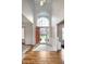 Inviting foyer with gleaming hardwood floors and a soaring arched window at 8228 Morel Dr, Indianapolis, IN 46256