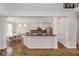 Kitchen with stainless steel appliances, white cabinets, brick backsplash, and dark countertops adjacent to a dining area at 8228 Morel Dr, Indianapolis, IN 46256
