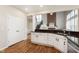 Spacious kitchen featuring modern appliances, granite countertops, white cabinets, and hardwood floors at 8228 Morel Dr, Indianapolis, IN 46256