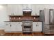 Charming kitchen features modern appliances, bright cabinets and a brick backsplash at 8228 Morel Dr, Indianapolis, IN 46256