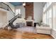 Spacious living room with fireplace, hardwood floors, staircase, and large windows at 8228 Morel Dr, Indianapolis, IN 46256
