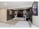 A finished basement living area featuring a TV, bookshelves, and posters at 8228 Morel Dr, Indianapolis, IN 46256