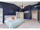 Serene main bedroom featuring a tray ceiling, calming color palette, and a ceiling fan at 8228 Morel Dr, Indianapolis, IN 46256