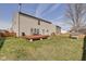 Backyard featuring a wood deck, a fire pit, and a well-maintained lawn for outdoor activities at 8316 S Swimming Hole Ln, Pendleton, IN 46064