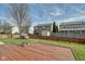 Backyard with a wood deck, a fire pit, fenced yard, and an animal house at 8316 S Swimming Hole Ln, Pendleton, IN 46064