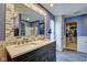 Modern bathroom featuring a dual sink vanity, decorative mirror, and walk-in shower at 8316 S Swimming Hole Ln, Pendleton, IN 46064