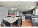 Contemporary kitchen featuring a large marble-top dining table, modern appliances, and attractive backsplash at 8316 S Swimming Hole Ln, Pendleton, IN 46064