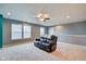 Spacious living room with a ceiling fan, carpet flooring, and windows with natural light at 8316 S Swimming Hole Ln, Pendleton, IN 46064
