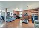 Cozy living room with hardwood floors, a gray sofa, and a treadmill for at-home workouts at 8316 S Swimming Hole Ln, Pendleton, IN 46064