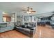 Comfortable living room featuring wood flooring, a ceiling fan, and an open layout into the kitchen at 8316 S Swimming Hole Ln, Pendleton, IN 46064
